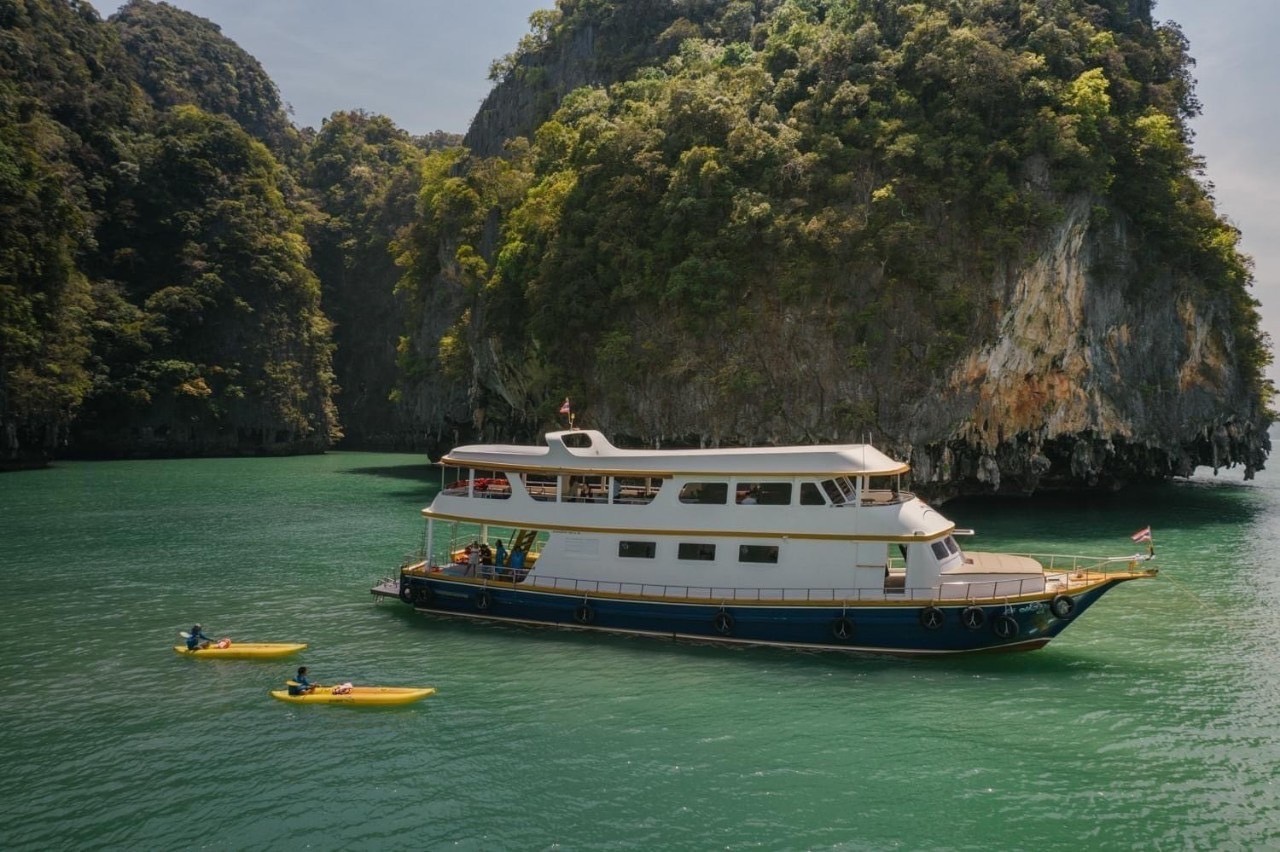 John Gray's Sea Canoe escort boat with kayakers in a Phang Nga Bay lagoon