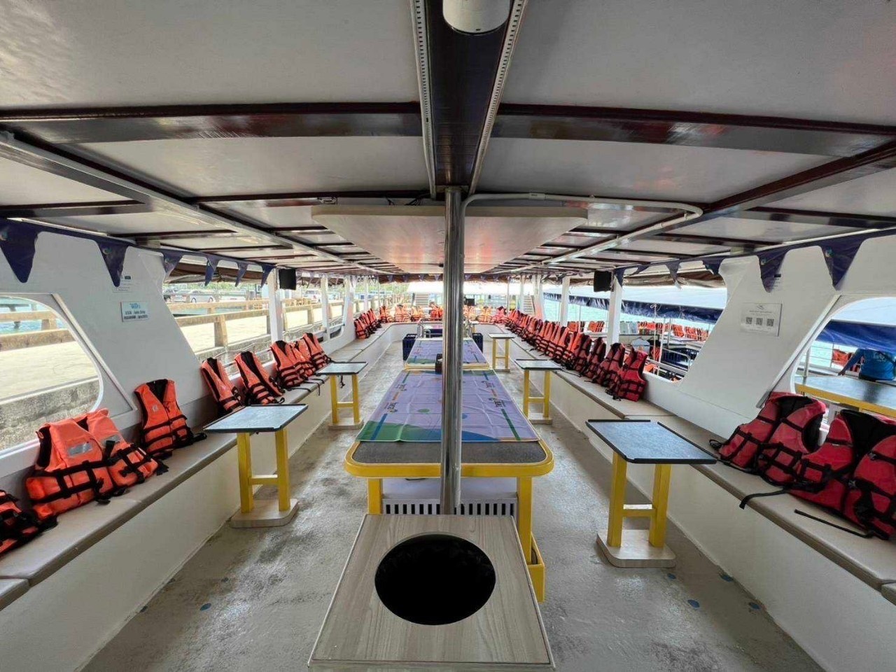 Onboard deck of the escort boat with life jackets and tables