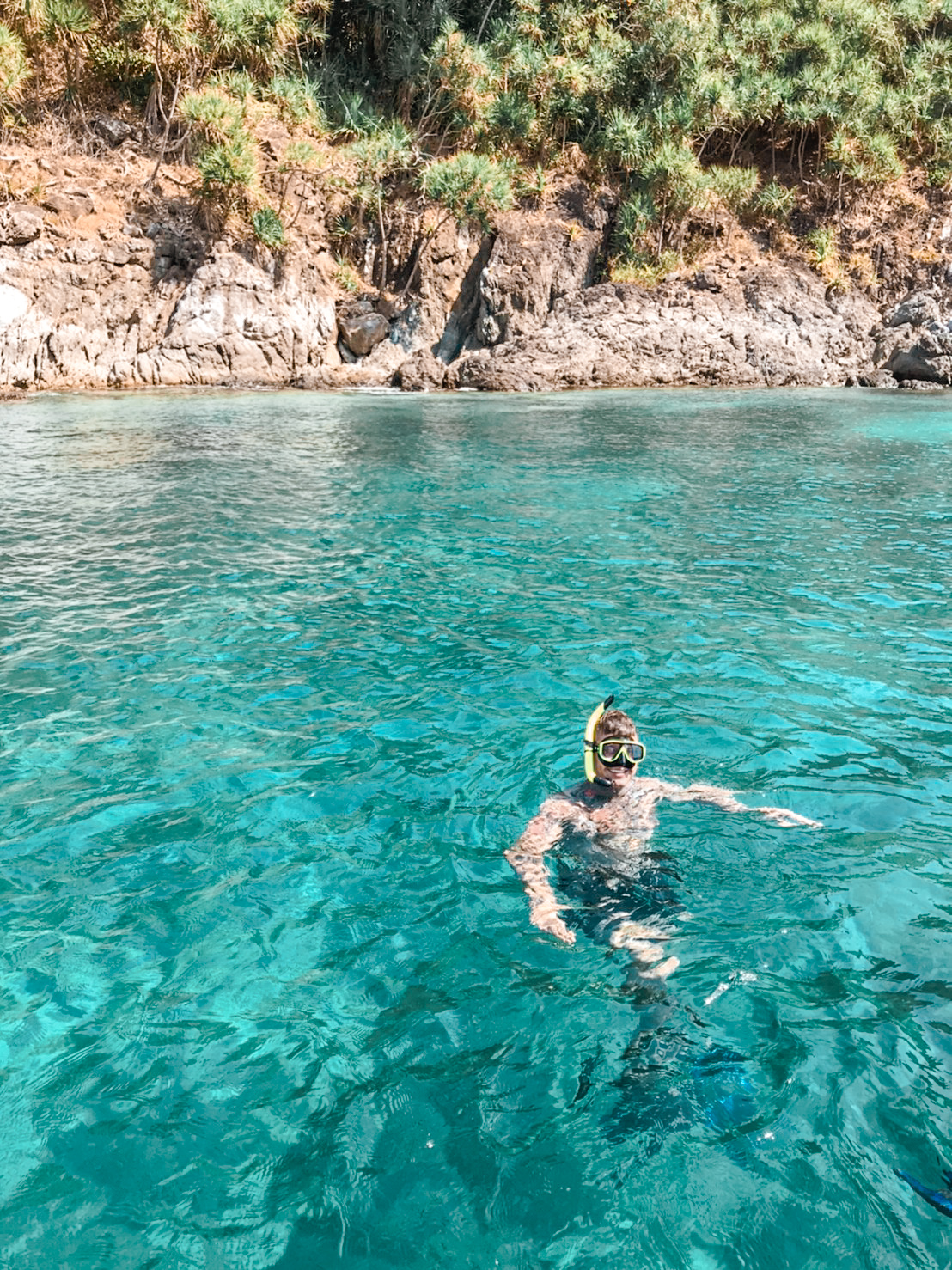 Snorkeller in clear water at Coral Island